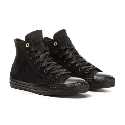 Black Converse Chuck Taylor All Star Suede shoes with black laces and classic low-top design, featuring white rubber soles.