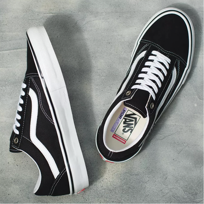 Black and white Vans Skate Old Skool shoes featuring classic design, canvas and suede upper, and rubber waffle outsole.